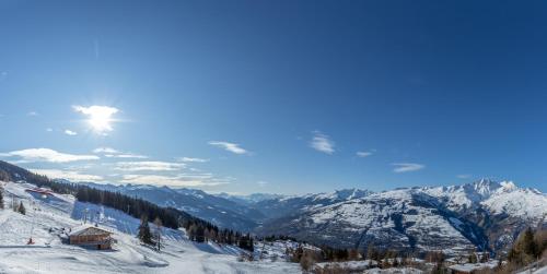 a view of a snow covered mountain with a cabin at Ridge302 in Bourg-Saint-Maurice