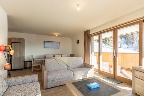 a living room with a couch and a table at Ridge302 in Bourg-Saint-Maurice