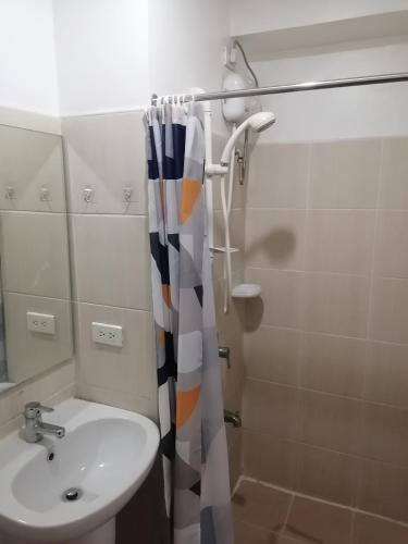 a bathroom with a sink and a shower at Roxas Blvd Stunning Studio Condo Near US Embassy in Manila