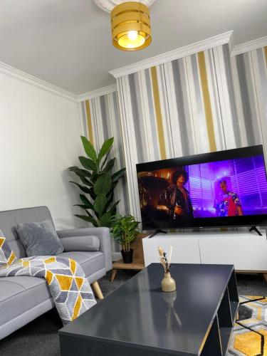 a living room with a large flat screen tv at Home in Medway in Gillingham