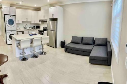 a living room with a couch and a kitchen at 温西民宿 Vancouver West Quiet Home in Vancouver