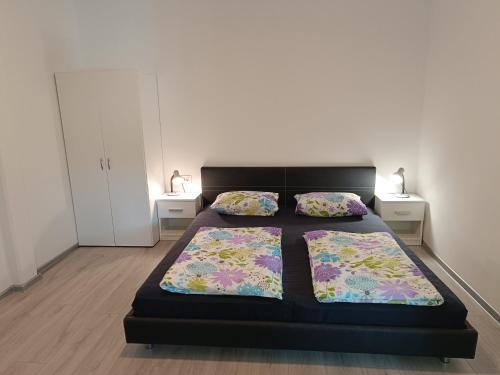 a bedroom with a bed and two night stands at Apartments Abc Ljubljana in Ljubljana
