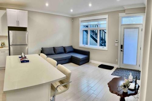 a living room with a couch and a table at 温西民宿 Vancouver West Quiet Home in Vancouver