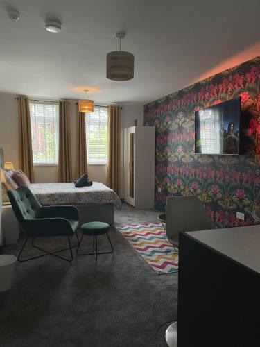 a hotel room with a bed and a chair at Luxury studio apartment near Birmingham citycentre in Birmingham