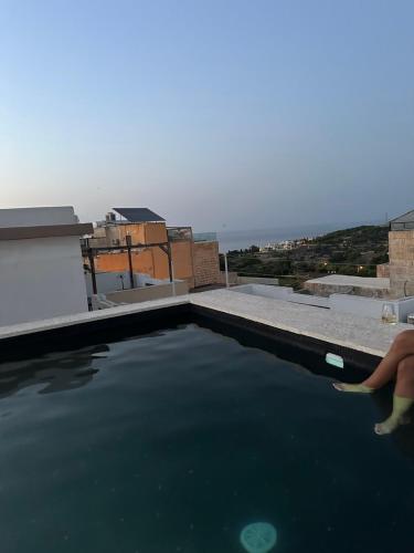 a swimming pool on the roof of a house at Luxury room in Gharghur in Għargħur