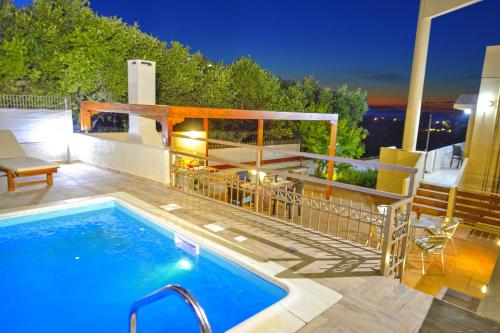 a swimming pool on top of a patio with at Dermitzogianni Villa in Kissamos