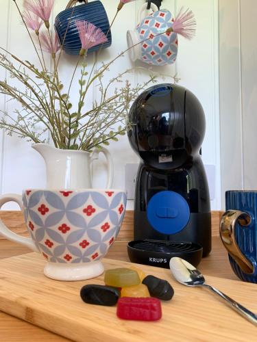 a coffee maker and a cup on a counter at St. Kew Shepherd Huts in Wadebridge