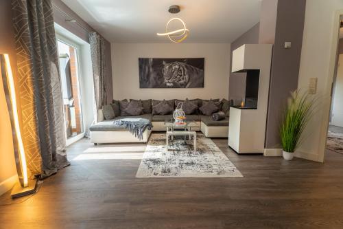 a living room with a couch and a table at Leeloo s Sunlight in Hodenhagen