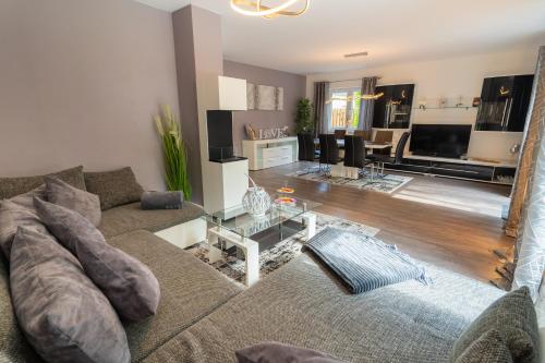 a living room with a couch and a table at Leeloo s Sunlight in Hodenhagen