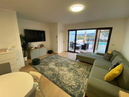 a living room with a couch and a table at POP'S POOL PLACE in Sečovlje