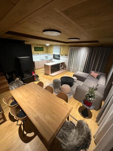 a living room with a table and a couch at CHALET COBURG in Telgárt