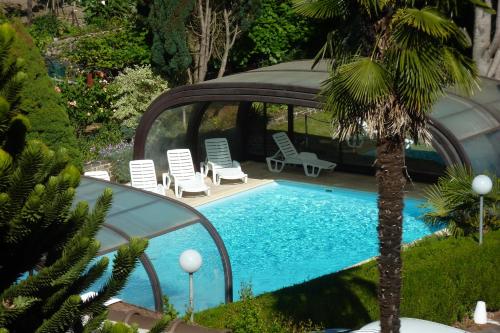 una piscina con sedie e gazebo di Hôtel du Lion d'Or a Entraygues-sur-Truyère