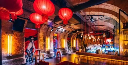 a bar with red lanterns hanging from the ceiling at Sissy20 Apartman in Budapest