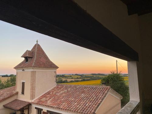 a view of a building with a clock tower at Château de labatut in Tourrenquets