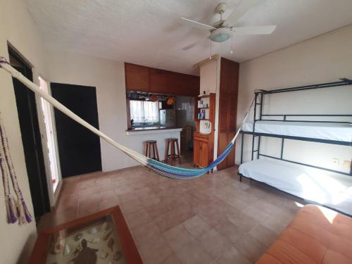 a bedroom with a bed and a hammock in it at Suites Los Arcos in Isla Mujeres