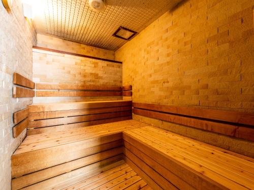 an empty sauna with wooden floors and a brick wall at APA Hotel Kyoto-eki Horikawa-Dori in Kyoto