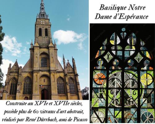 a church with a tower and a stained glass window at Charleville-Mézières: belle vue Place Ducale in Charleville-Mézières