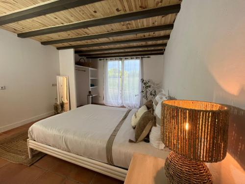 a bedroom with a large bed and a window at Domaine Royal Quercy in Monclar-de-Quercy