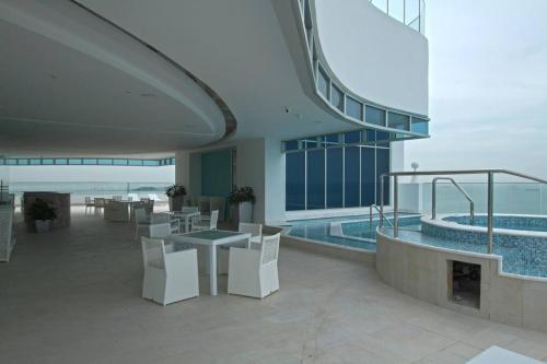 a building with a pool and a table and chairs at 07F Resort Breathtaking Ocean Views Panama Canal in ArraijÃ¡n