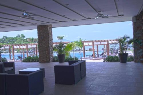 a lobby with chairs and a view of the water at 07F Resort Breathtaking Ocean Views Panama Canal in ArraijÃ¡n