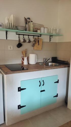 a kitchen with white cabinets and a sink at Regina di Dobrota in Kotor