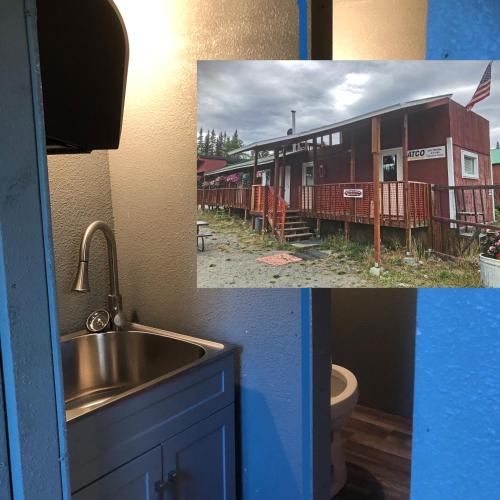 a bathroom with a sink and a train car at Nicolai's Mine Camp in Copper Center