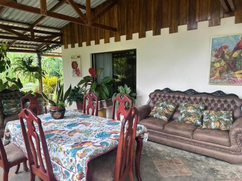 ein Wohnzimmer mit einem Sofa und einem Tisch in der Unterkunft RIVER SIDE LODGE in Horquetas