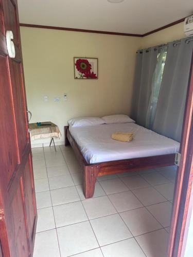 a small bedroom with a bed in a room at RIVER SIDE LODGE in Horquetas