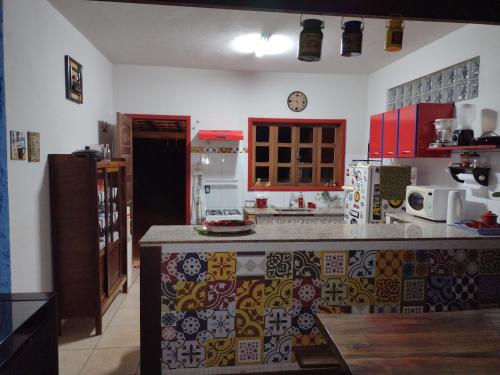 a kitchen with a counter top in a room at Chalé Cores da Mata in Brumadinho