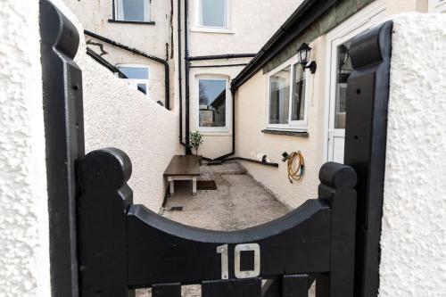 a door with the number on it next to a building at Stunning Holiday Home - Puddleduck - Centre of Coniston in Coniston