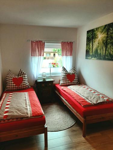 two beds sitting in a room with a window at Haus Waldblick in Liebenwalde