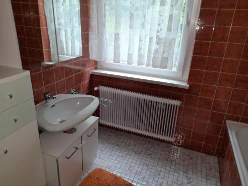 a bathroom with a sink and a toilet and a window at Margarethner Appartments in Sankt Margarethen bei Knittelfeld