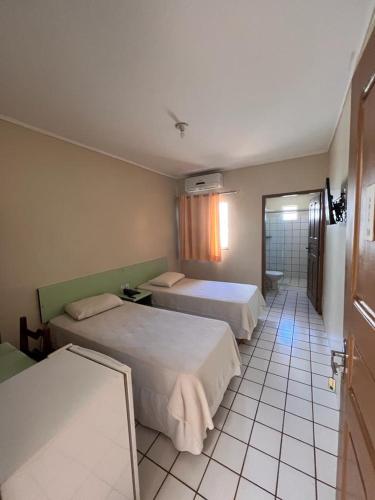 Postel nebo postele na pokoji v ubytování Hotel Peritoró