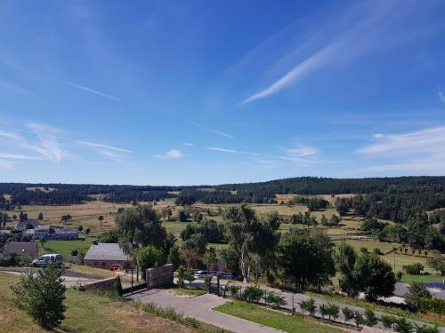 an aerial view of a small village in the hills at les abeilles du cantou in Termes