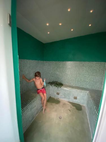 a man in a bathroom with a bath tub at Casa dos Arcos - Penina Villa in Portimão