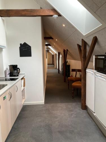 a hallway leading to a kitchen with wooden beams at Varde Bed and Kitchen in Varde
