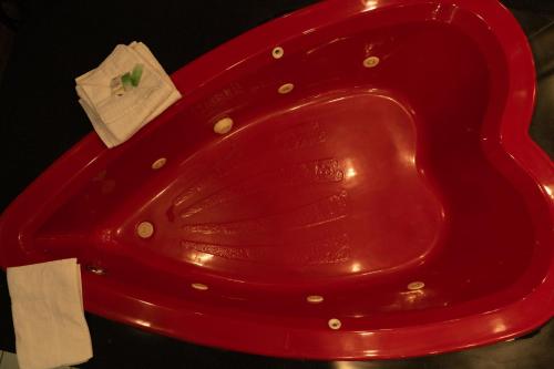 a red toilet seat with a piece of paper on it at Howard Johnson by Wyndham Niagara Falls in Niagara Falls