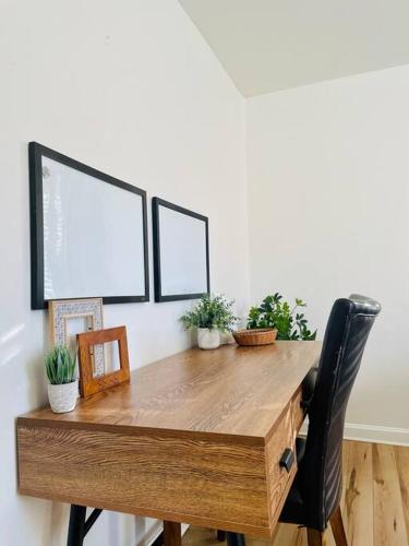 a wooden table with potted plants on top of it at Heavensville Haven - One bedroom apartments in Evansville