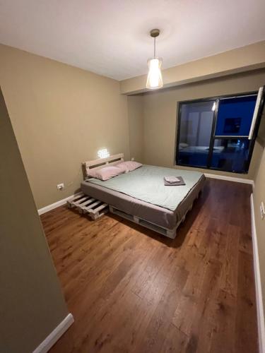 a bedroom with a bed and a wooden floor at Good vibes around in Floreşti