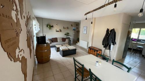 a room with a living room with a table and a couch at Chez Ced&Lolo in Béziers