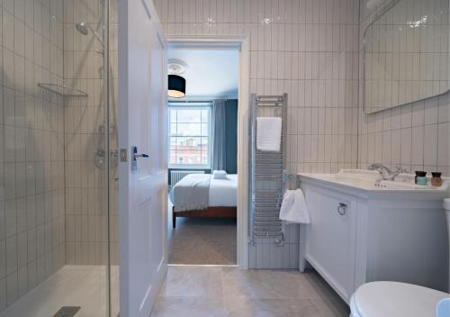 a bathroom with a shower and a sink and a toilet at Clifton Town House with Cinema Room Perfect for Groups, Families, Friends Hens & Stags! in Bristol