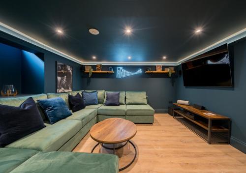 a living room with a couch and a table at Premium Designer 4 Bedroom Home in Clifton - 3 Bathrooms & Cinema Room in Bristol
