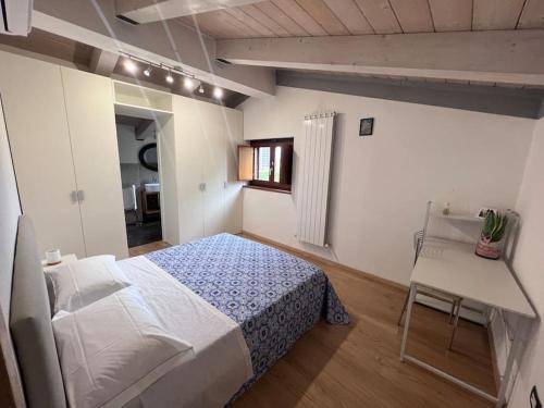 a bedroom with a bed and a table and a chair at Casa Linda in Siena
