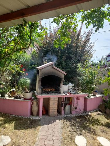 a outdoor oven in a garden with smoke coming out at VÉNUS in Dessenheim