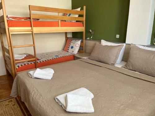 a bedroom with a bed with two bunk beds at Volkan Apartments in Ohrid