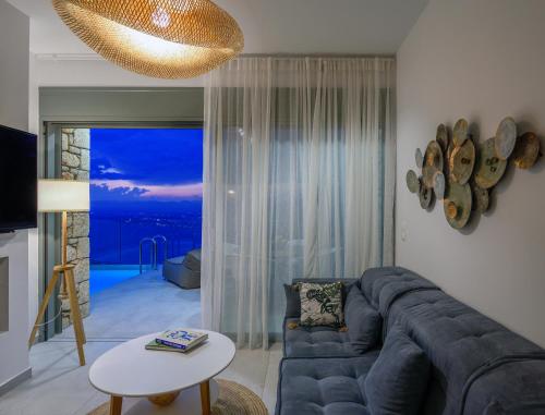 a living room with a couch and a table at Lithos Retreat 1 in Káto Sélitsa