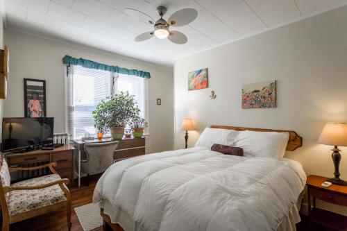 a bedroom with a bed and a desk and a television at Lakelawn B&B and Motel in Yarmouth
