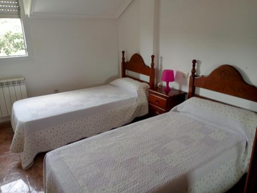 En eller flere senge i et værelse på Urbanizacion Corconera