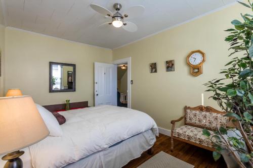 a bedroom with a bed and a clock on the wall at Lakelawn B&B and Motel in Yarmouth