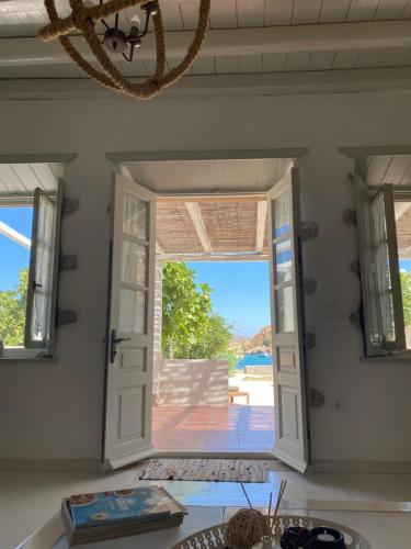 a room with a door open to a patio at Agnanti Beach House in Patmos